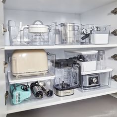 an organized pantry with various appliances and containers