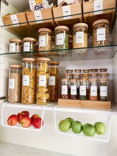 the shelves are filled with many different types of food and cereals in glass containers