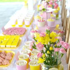 a long table filled with lots of food and desserts on top of it's sides