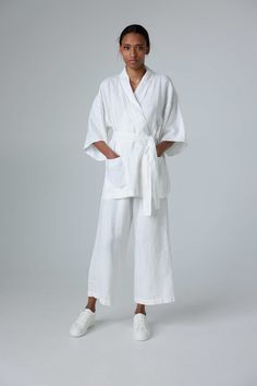 "Minimalist linen kimono jacket with raw-edge details. If you're interested in a shorter heavy-weight option, check our jacket YOI. STYLE DETAILS * Loose fit * Kimono sleeves & collar * Raw-edge details on the collar, sleeves & pockets * Side slits * Patch pockets * Belt included * French seams inside * Made from medium-weight linen SIZES & COLORS IN PICTURES * Model wears size S in color Off White. She is 178 cm (5'10\"). Bust - 85 cm (33\"), waist - 63 cm (25\"), hips - 86 cm (34\"). CUSTOMIZATION * Customization is possible, but such items are non-changeable & non-refundable * There is extra charge depending on the particular customization * If you want a customization, message us with your measurements and specific request NOTES ON SIZING AND COLOR * You can find Size Guide and Color C Handmade White Kimono With Kimono Sleeves, Elegant Linen Kimono With Kimono Sleeves, Beige Linen Beach Kimono, Beige Linen Kimono, White One-size Open Front Kimono, Linen Kimono, Kimono Sleeves, Linen Jacket, Jacket For Women