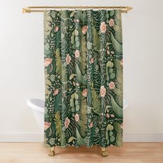 a green shower curtain with pink flowers and leaves on the outside, along with a white bath tub