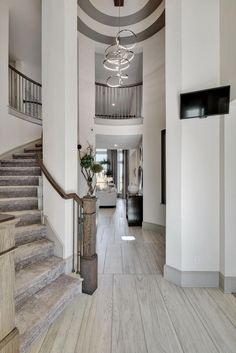 a large foyer with stairs and chandelier