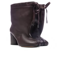 The Brown Tabi Drawstring Ankle Boot in 'Chic Brown' from Maison Margiela. This Italian-made boot features a Nappa upper with a leather sole and a drawstring top closure. It has a leather lining, a slouchy shaft, and a distinctive Tabi split toe. The boot stands on a heel approximately 75mm high with a shaft height of around 165mm. Nappa upper with leather sole Made in Italy Drawstring top closure Leather lining Slouchy shaft Tabi split toe Approx 75mm/ 3 inch heelApprox 165mm/ 6.5 inch shaft St