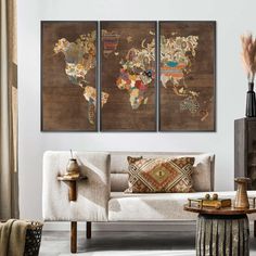 a living room with three pieces of art on the wall