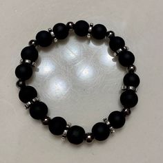 Matte black and gunmetal beaded bracelet with silver spacer beads. Additional gunmetal beaded bracelet optional. The larger beads are 8mm round glass beads. The smaller beads are 5mm iron round beads. The bracelets are approximately 17-17.5 cm in length each. Boys Bracelets, Ankle Bracelets Diy, Black Beaded Bracelets, Bracelets Design, Beads Bracelet Design, Glass Bracelet, Mens Beaded Bracelets, Pretty Bracelets, Glass Beaded Bracelets