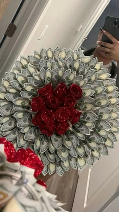 a person taking a selfie in front of a mirror with money wreath on it