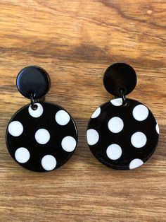 Dangling clip on earrings. Black and white polka dot circles dangling on hinged screwback  closures. Adjustable, lightweight.  Earrings are not intended to be worn while sleeping bathing or swimming. Not recommended for children under three.See more: https://www.etsy.com/ca/shop/CleverLittleEars While the cost of shipping makes returns or exchanges impractical, please do contact me with any concerns about your order and we will work together to address them.  By law, European buyers have 14 days Retro Black Round Earrings, Polka Dot Earrings, Black And White Earrings, Lightweight Earrings, Earrings Black, White Polka Dot, Polymer Clay Earrings, Clay Earrings, Clip On