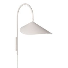 a white wall light with a long arm and an angled shade on the top of it