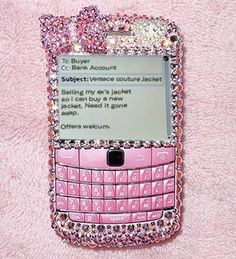 a pink cell phone covered in lots of swarong and jewels on it's side