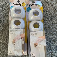 two white baby door knobs in packaging on carpet