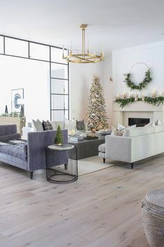 a living room filled with furniture and a christmas tree