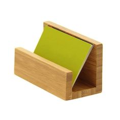 a wooden stand with a green note pad in it