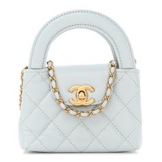 This is an authentic CHANEL Shiny Aged Calfskin Quilted Mini Nano Kelly Shopper in Light Blue. This mini bag is a twist on an archival Chanel bag, featuring a long crossbody chain strap. This dual top handle bag is quilted in shiny aged calfskin leather in blue, accented by aged gold hardware, including a Chanel CC turn-lock at the flap. This opens to a compact leather interior. Chic Blue Bag With Cc Turnlock Closure, Trendy Light Blue Luxury Bag, Luxury Light Blue Women's Bags, Blue Chanel Bag, Light Blue Chanel Bag, Chanel Mini Bag, 90s Chanel, Chanel Navy Blue Bag, Chanel Mini