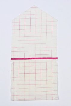 a piece of paper with pink lines on it and a white background behind it that appears to be cut in half