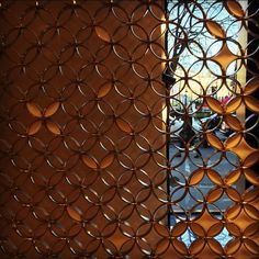 an image of a window that is made out of metal rings and circles on the outside