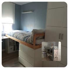 there is a small bed in the corner of this room with drawers on both sides