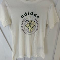 Tennis Graphic In Front Embroidered Adidas Logo Size Xs Brand New With Tags! Casual White T-shirt With Embroidered Logo, Trendy Tops With Embroidered Logo For Spring, Trendy Spring Tops With Embroidered Logo, Summer Cotton Tennis T-shirt, Summer Cotton Tennis Tops, Cotton Tennis Tops For Summer, White Graphic Tennis T-shirt, White T-shirt With Embroidered Logo For Spring, Casual Tennis Tops With Screen Print