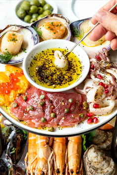 a platter filled with different types of seafood and other foods on it's sides