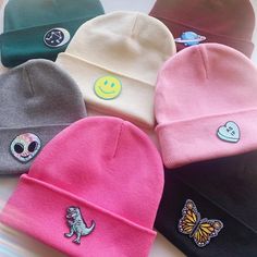 six beanies with different designs on them