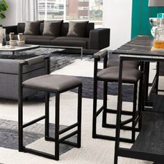 a living room filled with lots of furniture and a rug on top of a floor