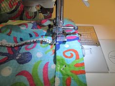 the sewing machine is working on the colorful fabric that has been sewned into it