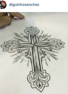 a drawing of a cross on paper