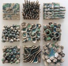 nine pieces of art made out of clay and shells on a white surface with other items in the background