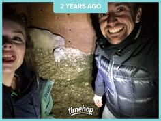 a man and woman standing next to each other in a room with sheep on the floor