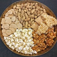 a bowl filled with nuts, rice and other foods on top of a black table