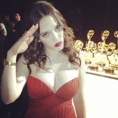 a woman in a red dress posing for the camera