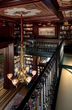 a chandelier hanging from the ceiling in a library