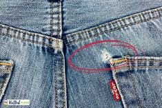 a pair of scissors in the back pocket of a blue jean's with red stitching