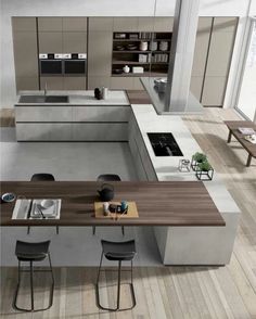 a modern kitchen with an island table and bar stools