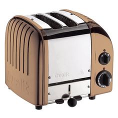 a gold and silver toaster sitting on top of a white table