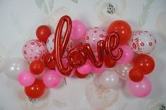 some balloons that say love are in the air