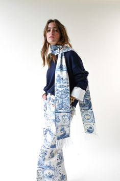 Delft Knit Scarf is our comfy wrap-around scarf with tiles printed along the length of the piece. The tile print showcases several hand-drawn tiles inspired by 17th century Dutch delftware and is complete with ivory fringe and our standard yellow label. 96" long by 5" wide 'Sisters II' artwork tile by Lauren Fuhr Yellow label at end 54% polyester, 20% nylon, 20% acrylic, 6% merino wool white All accessories are final sale. Your order will ship from our warehouse in FL, USA. Yellow Label, Tile Print, Delft, 17th Century, Knit Scarf, Merino Wool, Final Sale, Hand Drawn, Tile