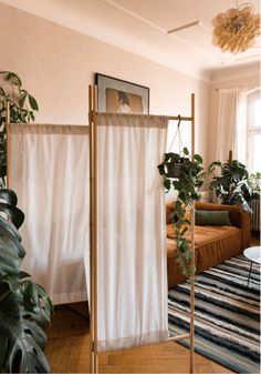 a living room filled with furniture and plants