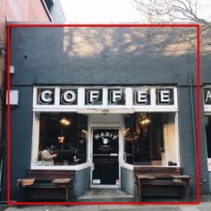 two wooden benches sitting in front of a coffee shop