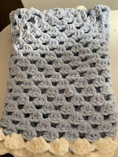 a crocheted blanket sitting on top of a table