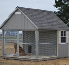 a dog house with a fence around it and a large dog in the yard next to it