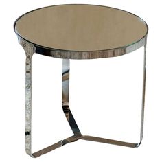 a round glass table with metal legs