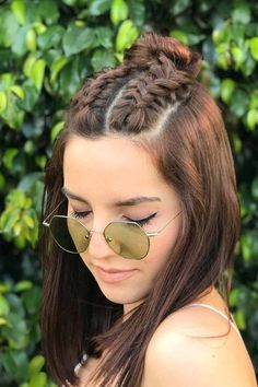 a woman with long hair wearing sunglasses