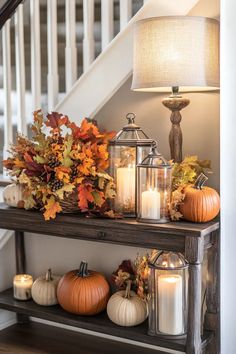 Fall entry table decor with lanterns and autumn foliage Home Entrance Table Decor, Fall Decor Foyer Table, Thanksgiving Entryway Table Decor, Fall Centerpiece Decor, Fall Hallway Table Decor, Fall Doorway Decor Entrance, Autumn Entryway Decor, Fall Entrance Decor Ideas, Fall Ladder Decor Ideas