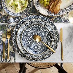 a table topped with plates and silverware