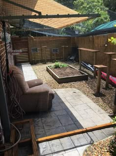 an outdoor area with lots of plants and furniture