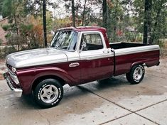 an older pickup truck parked in a driveway