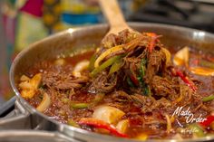 a pot filled with meat and vegetables on top of a stove