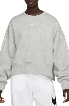 An embroidered Swoosh adds minimal branding to this cozy fleece sweatshirt cut for a relaxed, oversized fit that's enhanced by the dropped shoulders. 22" length (size Medium) Crewneck 80% cotton, 20% polyester Machine wash, tumble dry Imported Nike Trends, Sweatshirts Nike, 2024 Clothes, Nike Sportswear Phoenix Fleece, Ski Team, Nike Crew Neck, Nike Sportswear Women, Clothes Wishlist, Reunion Shirts