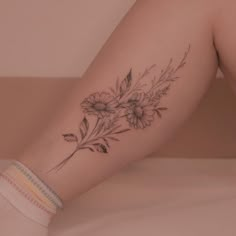 a woman's leg with flowers on it