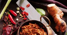 the food is prepared and ready to be eaten on the table with vegetables around it